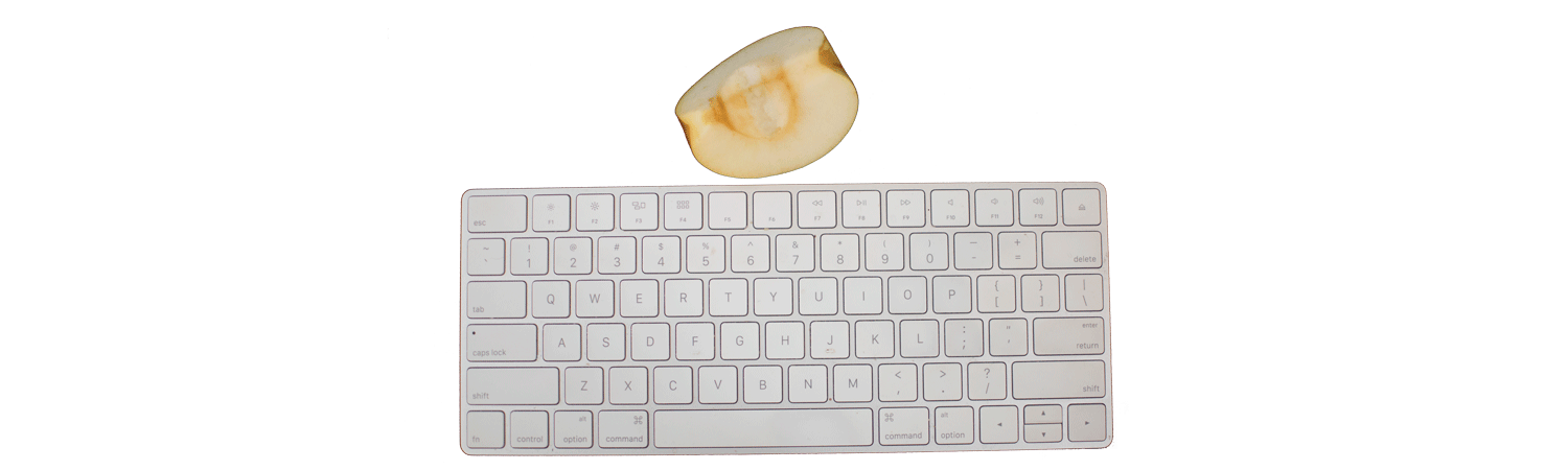 Image of Mac keyboard with a quarter of apple above it.